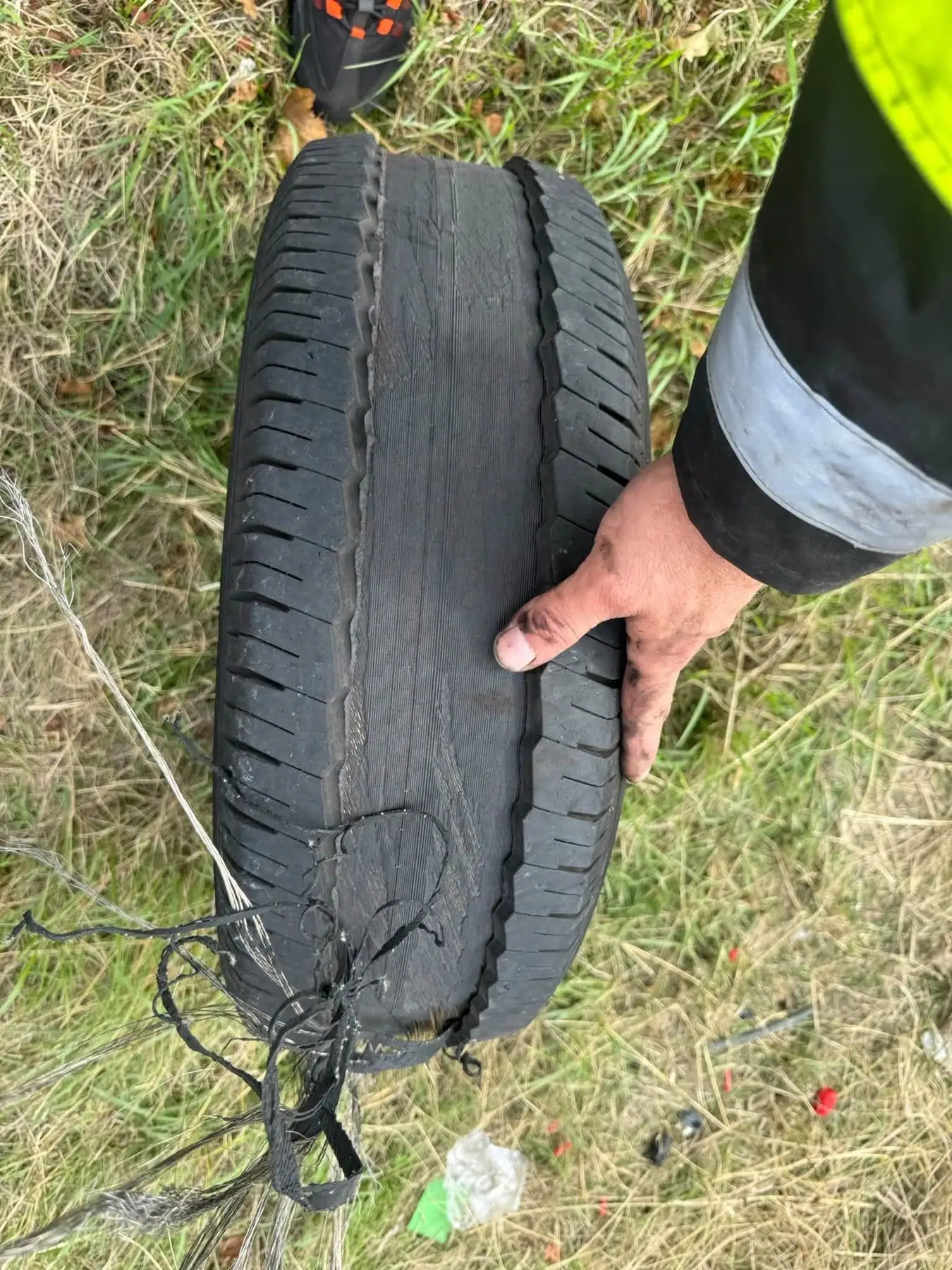 Blown-out van tyre laid on the verge after being removed