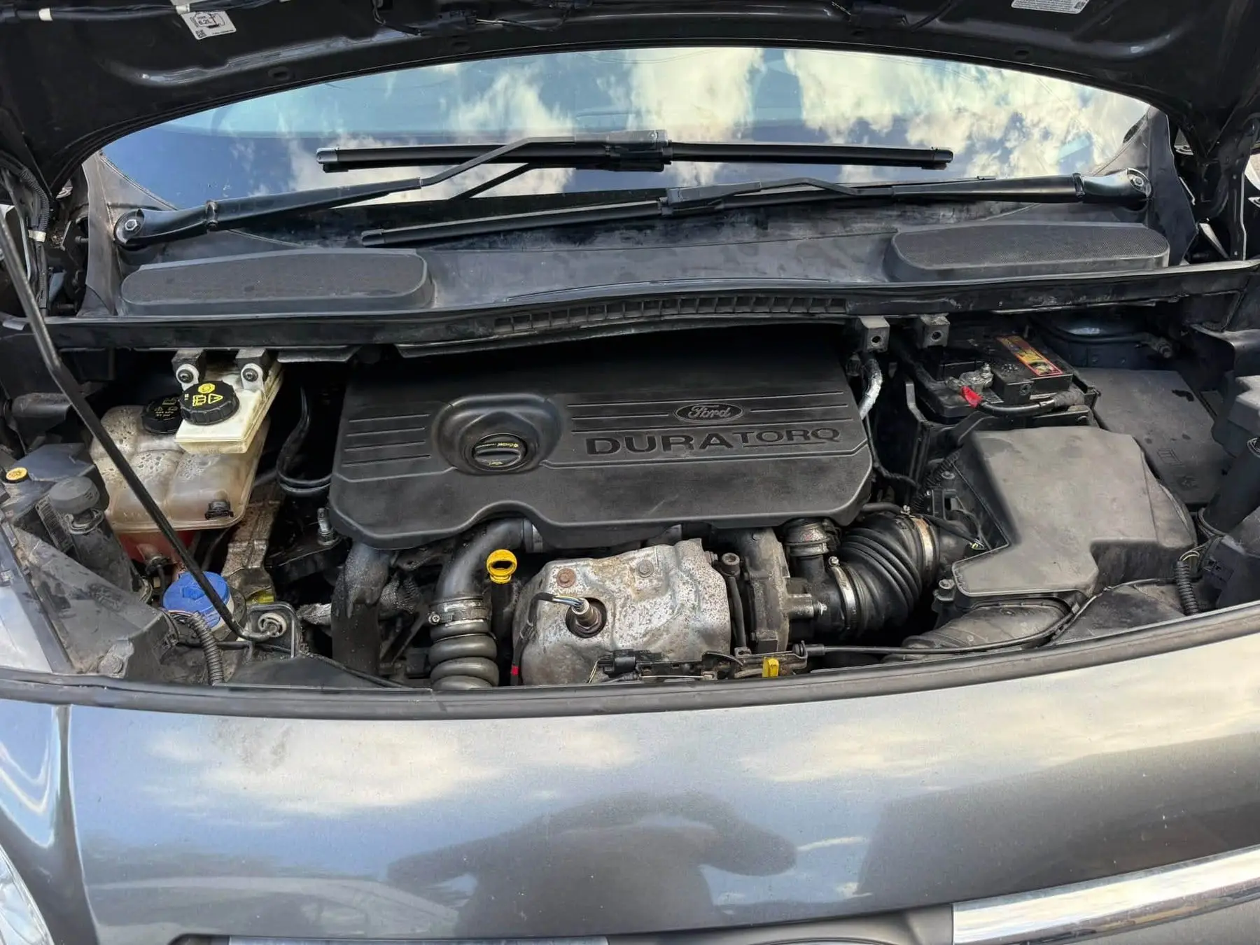 Bonnet up on a diesel engine bay during a mobile service