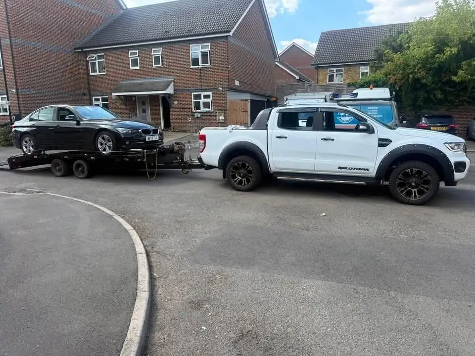 LTR Ford Ranger and trailer collecting a saloon from a residential close
